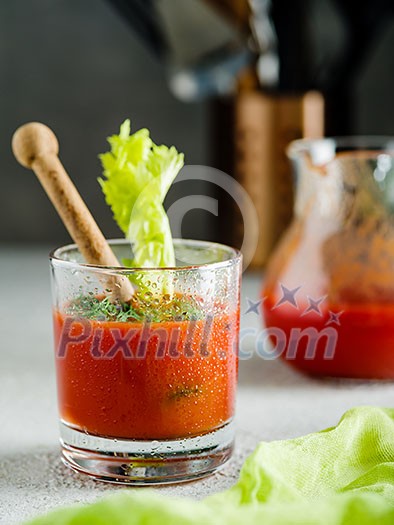 Tomato juice in glass with celery