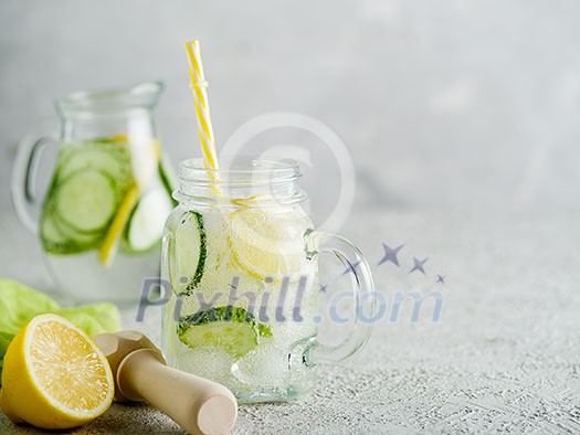 Fresh Summer Drink. Healthy detox fizzy water with lemon and cucumber in mason jar. Healthy food concept. Detox diet. Fresh Summer Drink. Healthy detox fizzy water with lemon and cucumber in mason jar. Healthy food concept. Detox diet.