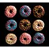 Variety of colorful tasty glazed donuts on a black background.