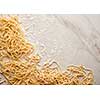 Dried egg noodles. Raw Fresh Spaghetti.