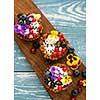 Dessert with sunflower seeds, yogurt and fresh berries on blue wooden table