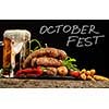 Grilled sausages with a glass of beer on a wooden table. Rustic style. Snacks for the Oktoberfest.