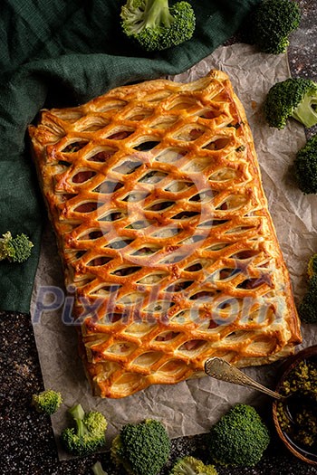 Chicken pie with broccoli from puff pastry top view.