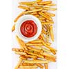 French fries with ketchup top view over white background