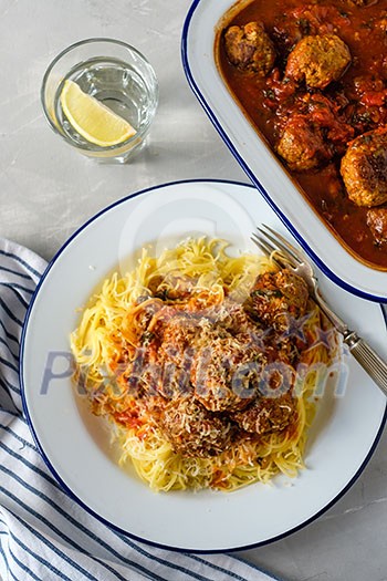 Delicious homemade meat balls in tomato sauce with spaghetti. Top view.
