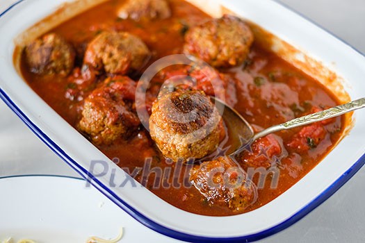 Close up of delicious homemade meat balls in tomato sauce Close up of delicious homemade meat balls in tomato sauce