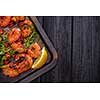 Large grilled BBQ shrimp with sweet chili sauce, green onion and lemon, copyspace.