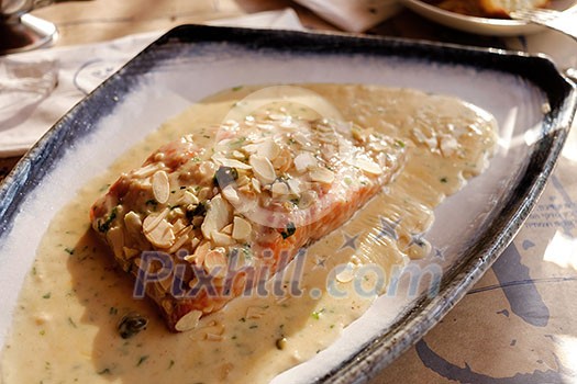 Salmon with cream sauce and nuts