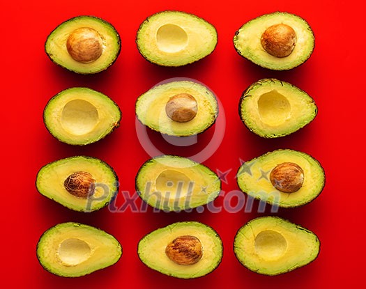  Avocado on the red background. Pattern with avocado. Abstract background.
