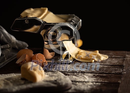 Homemade dough preparation process for pasta on a pasta machine. Traditional italian cuisine. Homemade dough preparation process for pasta on a pasta machine. Traditional italian cuisine.