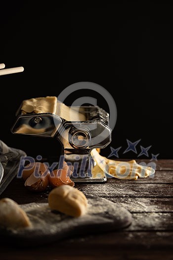 Homemade dough preparation process for pasta on a pasta machine. Traditional italian cuisine. Homemade dough preparation process for pasta on a pasta machine. Traditional italian cuisine.