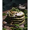 Pancakes with spinach and pumpkin seeds on a wooden table. Country style.