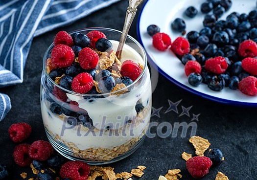Healthy breakfast with Homemade granola. Muesli, fresh berries and yogurt in glass  jar