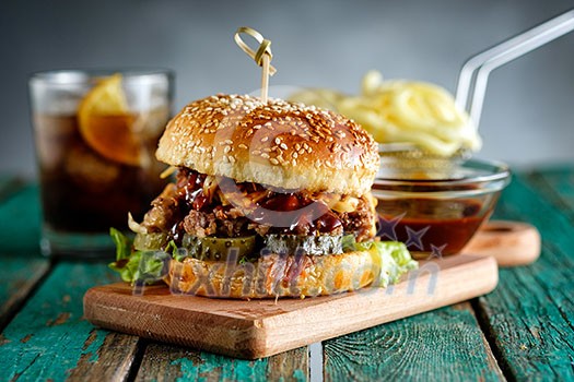 Gourmet Pulled Pork Burger with with Coleslaw and barbecue Sauce on Wooden Table. Gourmet Pulled Pork Burger with with Coleslaw and barbecue Sauce on Wooden Table.