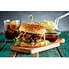 Gourmet Pulled Pork Burger with with Coleslaw and barbecue Sauce on  Wooden Table.