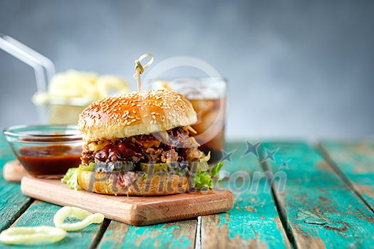 Gourmet Pulled Pork Burger with with Coleslaw and barbecue Sauce on Wooden Table. Gourmet Pulled Pork Burger with with Coleslaw and barbecue Sauce on Wooden Table.