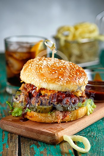 Gourmet Pulled Pork Burger with with Coleslaw and barbecue Sauce on Wooden Table. Gourmet Pulled Pork Burger with with Coleslaw and barbecue Sauce on Wooden Table.