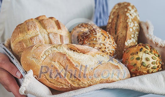 Bread assortment in the hands of the baker, horizontal banner, close-up. Bread assortment in the hands of the baker, horizontal banner, close-up.