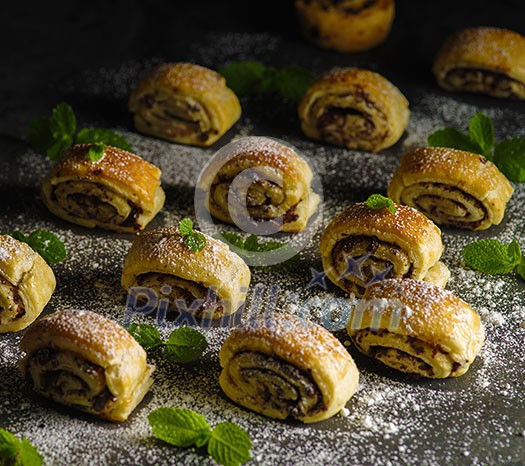 Puff pastry with chocolate on a dark table. Country style.