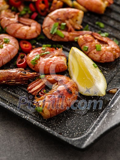 Large grilled BBQ shrimp with sweet chili sauce, green onion and lemon Large grilled BBQ shrimp with sweet chili sauce, green onion and lemon