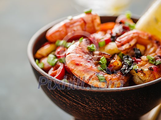 Closeup of Large grilled BBQ shrimp with sweet chili sauce, green onion and lemon