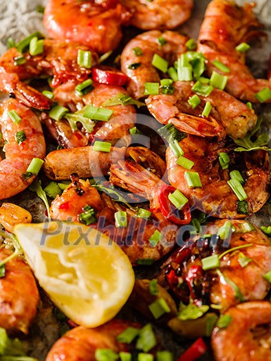 Large grilled BBQ shrimp with sweet chili sauce, green onion and lemon Large grilled BBQ shrimp with sweet chili sauce, green onion and lemon