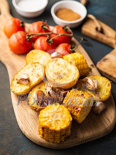 Roast vegetables on the wooden cutting board 