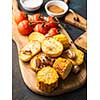 Roast vegetables on the wooden cutting board 