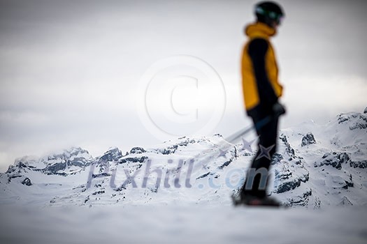 Skier skiing downhill in high mountains Skier skiing downhill in high mountains
