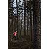 Young woman running outdoors in a forest, going fast (motion blurred image)