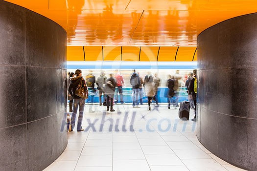 People rushing through a subway corridor (motion blur technique is used to convey movement) People rushing through a subway corridor (motion blur technique is used to convey movement)
