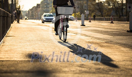 Bikers on a city street in warm evening sunlight Bikers on a city street in warm evening sunlight