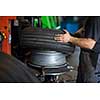 Tyre change - wheel balancing or repair and change car tire at auto service garage or workshop by mechanic