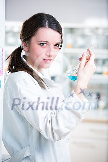 Portrait of a female researcher/chemistry student carrying out research in a chemistry lab (color toned image; shallow DOF)