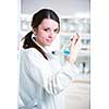 Portrait of a female researcher/chemistry student carrying out research in a chemistry lab (color toned image; shallow DOF)