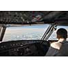 Pilot in a commercial airliner airplane flight cockpit during flight