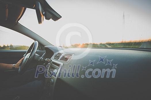 Man driving a car moving fast on a highway (motion blurred image) Man driving a car moving fast on a highway (motion blurred image)