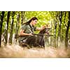 Autumn hunting season. Hunting. Outdoor sports. Woman hunter in the woods