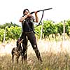 Autumn hunting season. Hunting. Outdoor sports. Woman hunter in the woods with her well trained dog