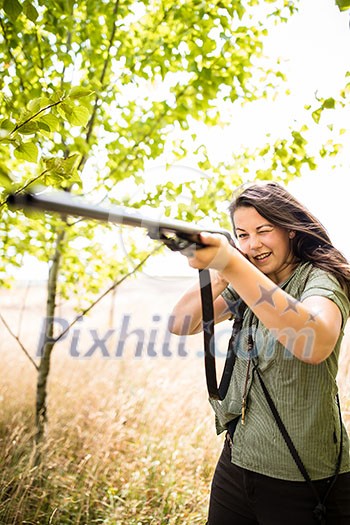 Autumn hunting season. Hunting. Outdoor sports. Woman hunter in the woods Autumn hunting season. Hunting. Outdoor sports. Woman hunter in the woods
