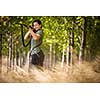 Autumn hunting season. Hunting. Outdoor sports. Woman hunter in the woods