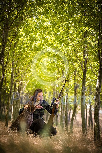 Autumn hunting season. Hunting. Outdoor sports. Woman hunter in the woods Autumn hunting season. Hunting. Outdoor sports. Woman hunter in the woods