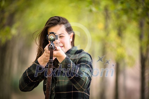 Autumn hunting season. Hunting. Outdoor sports. Woman hunter in the woods Autumn hunting season. Hunting. Outdoor sports. Woman hunter in the woods
