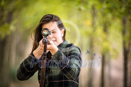 Autumn hunting season. Hunting. Outdoor sports. Woman hunter in the woods