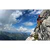 Young man climbing on a rock in Swiss Alps - via ferrata/klettersteig