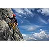 Young man climbing on a rock in Swiss Alps - via ferrata/klettersteig