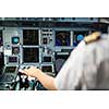 Pilot's hand accelerating on the throttle in  a commercial airliner airplane flight cockpit during takeoff