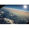 View from a cockpit of a commercial airliner airplane over a beautiful mountain range