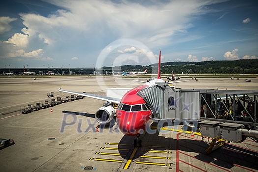 Commercial flight aircraft in airport with passangers boarding