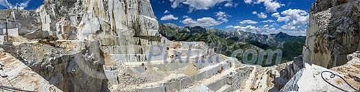 High stone mountain and marble quarries in the Apennines in Tuscany, Carrara Italy. Open marble mining. High stone mountain and marble quarries in the Apennines in Tuscany, Carrara Italy. Open marble mining.
